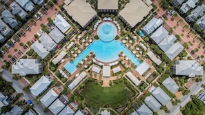 An aerial view of a residential area with a central swimming pool surrounded by houses and greenery. - Spacious 30A Home Steps to Beach With King Suites and Loft Space (Panama City Beach)
