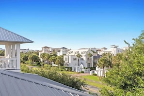A residential area with white houses, a gazebo, and palm trees. - Spacious 30A Home Steps to Beach With King Suites and Loft Space (Panama City Beach)