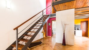 A staircase with a wooden handrail and metal balusters, leading to a second floor. - Holiday Home "Can Cuixa" with Pool, Wi-Fi, Air Conditioning & Garden (Santa Margarita)