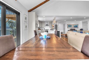 Spacious living space with a large dining table, kitchen area, and comfortable seating area.