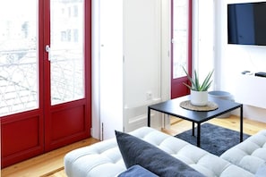 Relax in this stylish living room with a city view, comfortable sofa, and flat-screen TV.