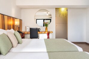 A hotel room with a bed, a desk, a chair, a coffee machine, a phone, and a mirror. - Lato Annex Boutique Rooms (Heraklion)
