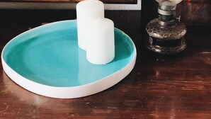 A teal tray with two white candles and a vintage-style lamp on a wooden table. - Dolce Vivere by Konnect, Gaios Paxos (Paxos)