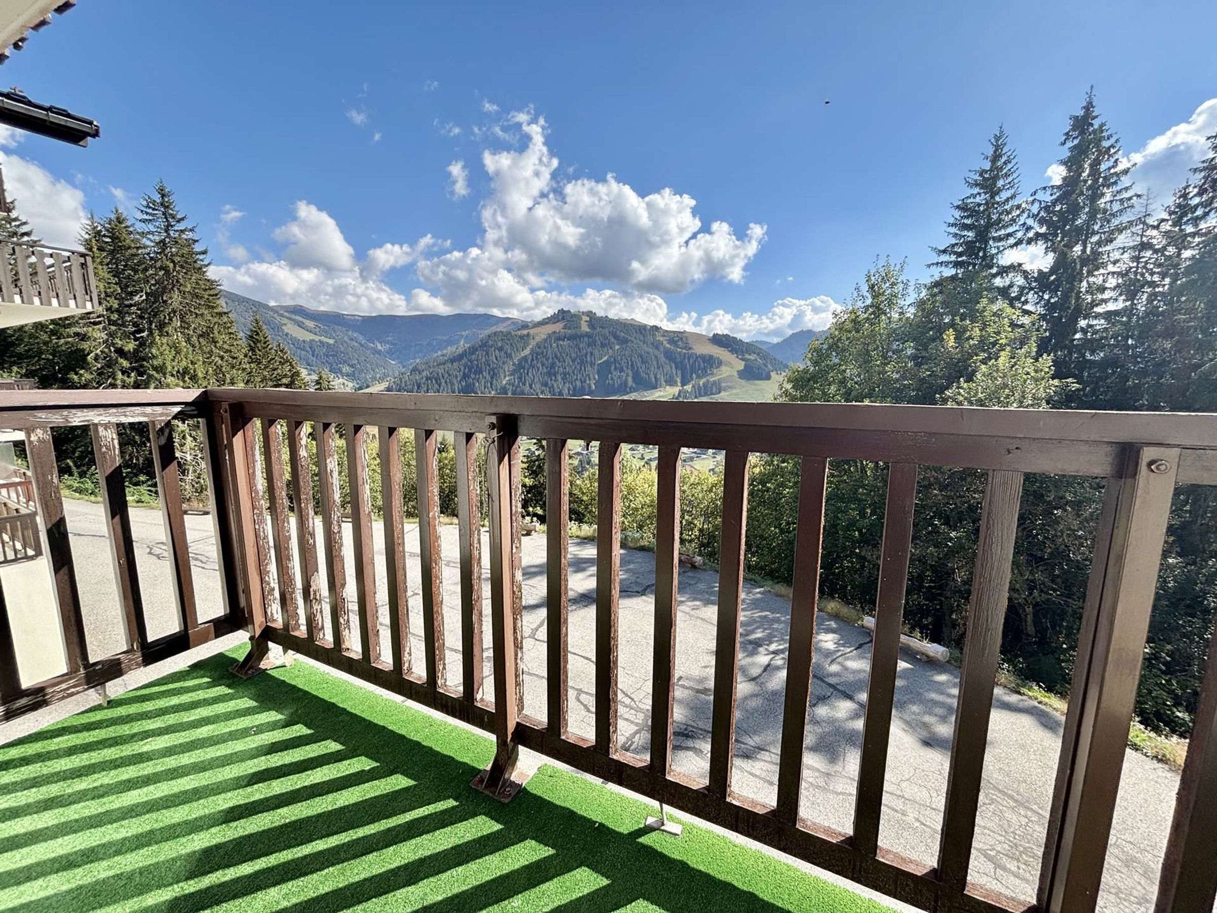 A balcony with a view of a mountainous landscape.