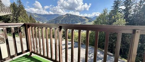 A balcony with a view of a mountainous landscape.
