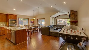 A spacious kitchen with wooden cabinets, a large island, and a foosball table. - AC, Custom Bunks, Bubble Hockey, Sauna, Walk to Heavenly/ Lake, Grill – Tahoe Woods Paradise (South Lake Tahoe)