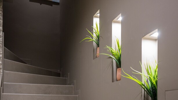 A staircase with a modern design, flanked by wall-mounted planters with green plants. -  MIRMA CITY studio & apartment (Chania)