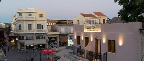 A building with a sign reading "Mirma City Studio & Apartment".