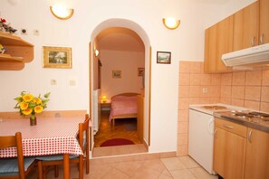 Fridge, stovetop, cookware/dishes/utensils, dining tables