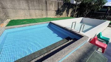 Una piscina con borde de azulejos y escalones para entrar.