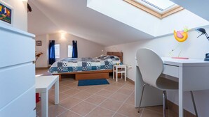 A compact bedroom with a skylight, a bed, a desk, and a chair. - Holiday apartment Tinka in centre of Baska with seaview (Baška)