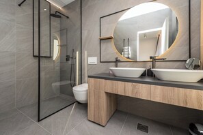 A modern bathroom with a glass-enclosed shower, a toilet, and a vanity with two sinks and a large mirror. - Villa Aria (Novalja)