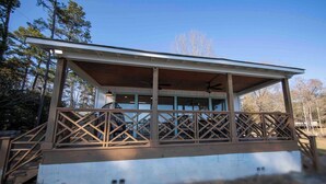 A covered outdoor area with a wooden deck and a ceiling fan. - Sunsets and Ramp and Dock Access on Lake Wateree (Camden)