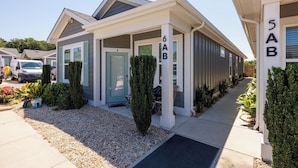 A modern residential building with numbered doors labeled A, B, and C.