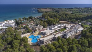 An aerial view of a resort with a swimming pool, multiple buildings, and a coastline. - Futura Club Spiagge Bianche (Syracuse)