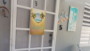 A door with a sign reading "Playa Escondida" and a number "5" on it. - Playa Escondida (Fajardo)
