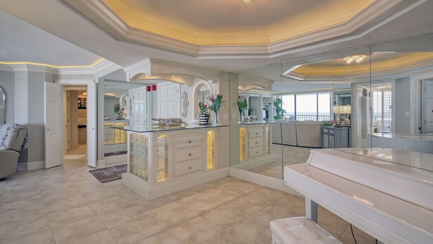 A spacious kitchen with a central island, a large mirror, and a view of the outdoors. - Wake up to beautiful ocean views!!! (MYRTLE BEACH)
