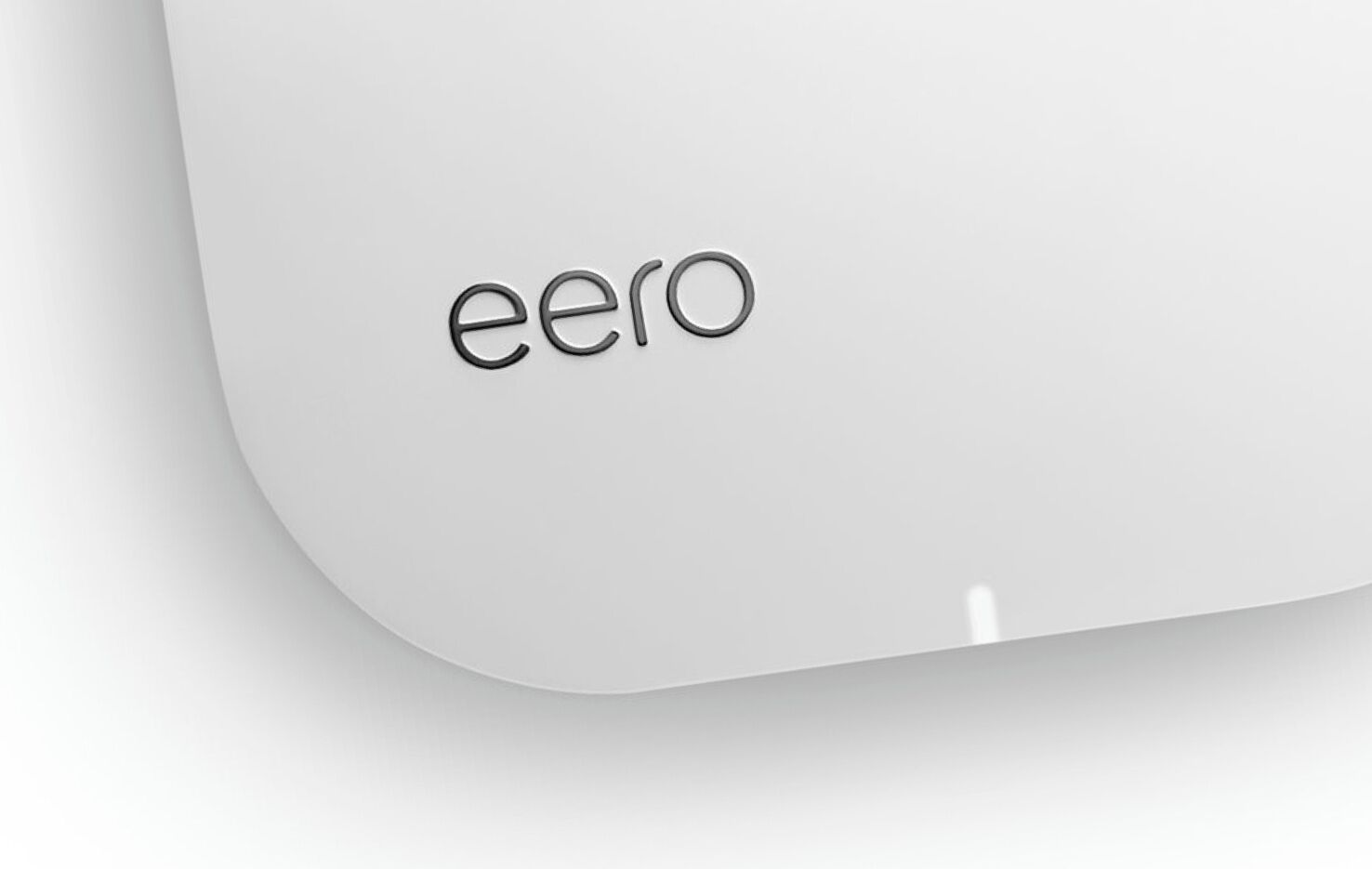 A white, curved surface with the word "eero" embossed on it.