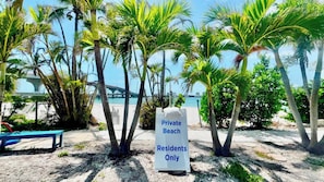 A private beach area with a sign indicating it is for residents only.