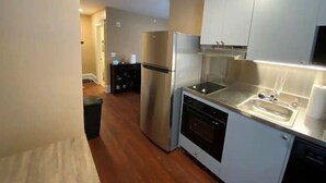 A compact kitchen with stainless steel appliances, a dishwasher, and a small countertop sink. - Apt 3A Lake Bomoseen Inn “The Dog” with boat slip. (Castleton)