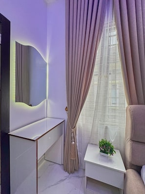 A modern bedroom with a minimalist design, featuring a bed, a bedside table with a plant, and a large mirror. - 3 Bedrooms Villa Duplex in Lekki Lagos Nigeria (Lekki)