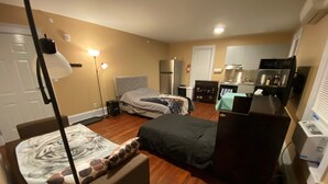A compact hotel room with two beds, a kitchenette, a small bathroom, and a TV. - Apt 3C Lake Bomoseen Inn “The Dog” with boat slip.  (Castleton)