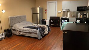 A compact hotel room with a bed, a kitchenette, a refrigerator, and a small cabinet. - Apt 3C Lake Bomoseen Inn “The Dog” with boat slip.  (Castleton)