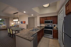 A modern kitchen with granite countertops, stainless steel appliances, and wooden cabinets. - Las Vegas Luxury 2 Bed 2 Bath Condo (Sleeps 6) (Las Vegas)