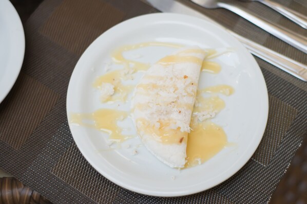 A plate with a slice of cake on a placemat.