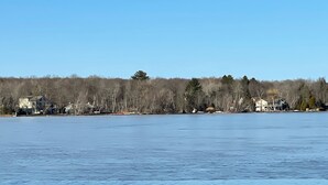 A frozen lake with houses and trees in the background. - STOP SCROLLING & CHECK OUT OUR REVIEWS. NO ADDITIONAL FEES TO ENTER COMMUNITY (Pocono lake)