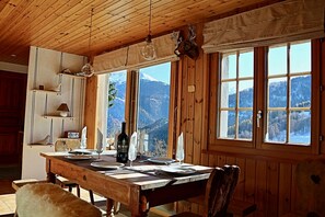 Enjoy a romantic dinner for two in this cozy dining area with a view of the snow-covered mountains.
