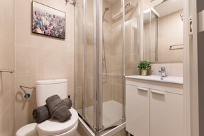 Shower, hair dryer, towels, toilet paper