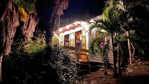 A single-story building with a porch, surrounded by tropical vegetation. - Your home away from home on the Farm, 4 Casitas Bed n Breakfast - Casita 1 (Cabo Rojo)