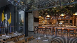 A restaurant with a bar area, high ceilings, and a checkered floor. - W Nashville (Nashville)