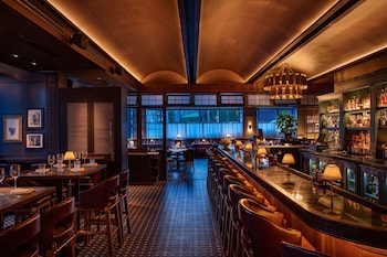 Enjoy a drink at the bar with a view of the outside through the large window. at W Nashville