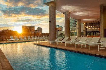 Relax by the pool surrounded by a deck and city views. at W Nashville