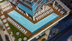 An aerial view of a rooftop pool area with multiple lounge areas and a central swimming pool. - W Nashville (Nashville)