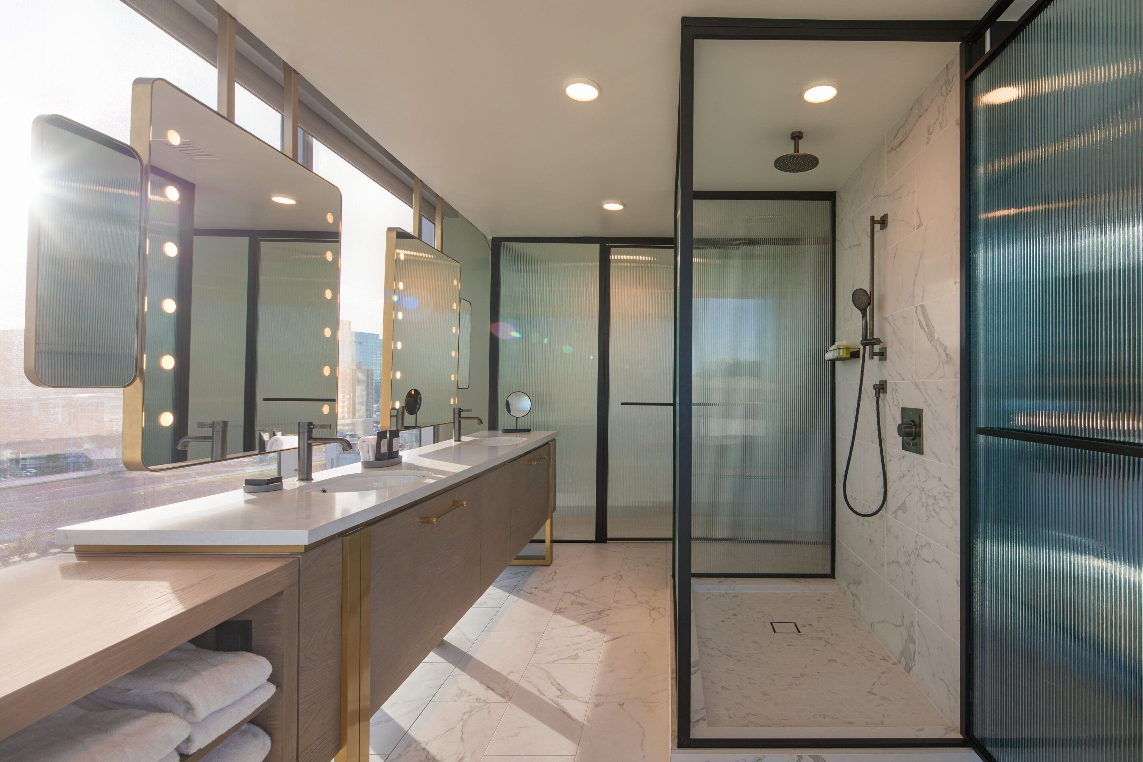 e-wow one-bedroom presidential king suite | bathroom | free toiletries, hair dryer, bathrobes, slippers