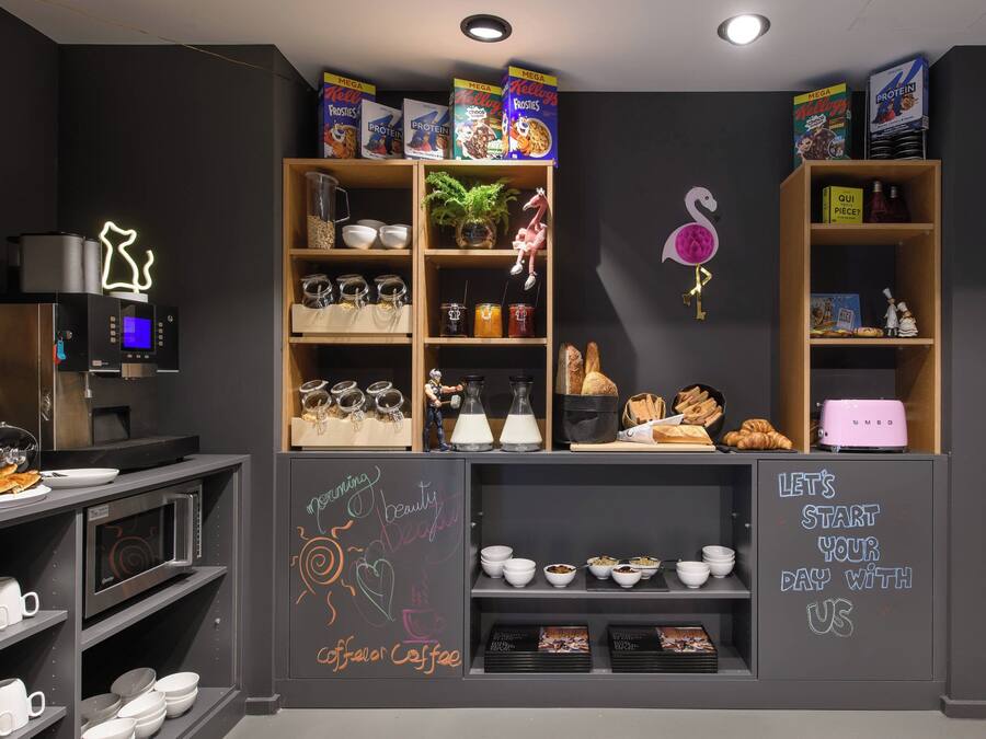 A breakfast bar with cereal boxes, a coffee machine, and a chalkboard with motivational writing.
