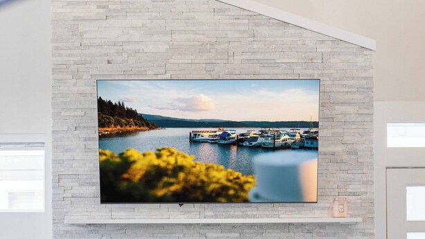 A modern living room with a fireplace, a mounted TV, and a cozy seating area. - Coeur d'Alene Townhome Modern New Downtown Shops Beach (CDA)