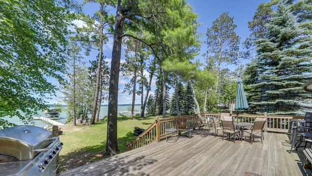 A wooden deck with outdoor furniture, a grill, and a view of the lake. - 21 Mi to Slopes! Torch Lake Home w/ Private Beach (Rapid City)