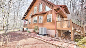A log cabin with a wooden deck and a covered staircase. - Cozy Hayesville Retreat w/ Deck & Mtn Views! (Hayesville)