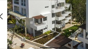 A multi-story residential building with balconies, a rooftop garden, and a paved driveway. - Jungle vibe,  with  Sea side breezes , EXPERIENCE THE MAYAN RIVIERA  (Akumal)