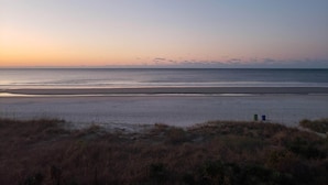 A beach with a clear sky and calm sea. - Quiet second floor Beachfront Condo with two bedrooms and a sleeper sofa. (Myrtle Beach)