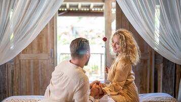 Couples can relax together on a cozy bed with a patterned bedspread, surrounded by rustic charm.