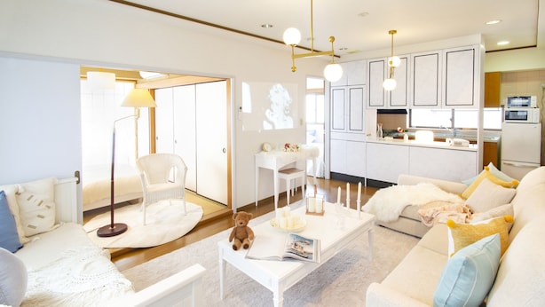 A modern living room with a sofa, a coffee table, and a chair. There is a kitchen area in the background. - HARMONIA Tokyo Horikiri (Tokyo)