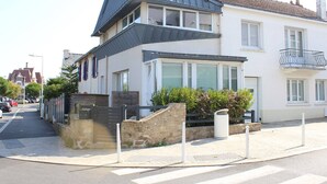 A modern two-story house with a sloped roof, large windows, and a balcony. - Cozy 3-Level House in La Baule, 2 Terraces, Near Beach & Shops, Sleeps 6 (La Baule)