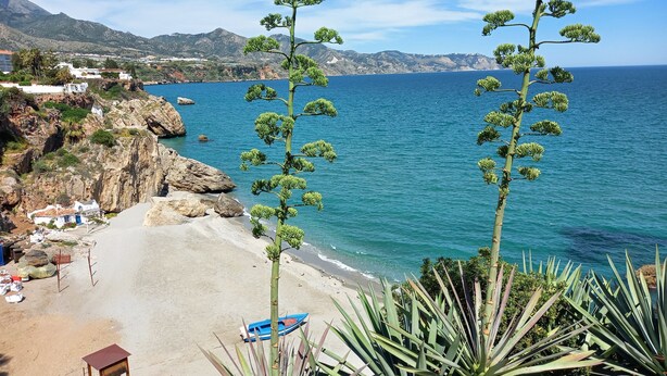 A coastal view with a beach, rocky cliffs, and a clear blue sea. - Villa Las Tres J (Torrox Costa)