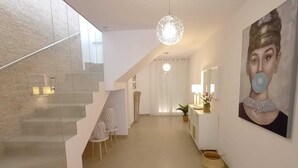 A modern interior with a staircase, a dining area, and a living space. - Villa Las Tres J (Torrox Costa)