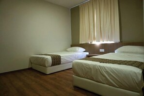 A hotel room with two beds, a wooden floor, and a window with curtains. - Yew Hotel (Miri)